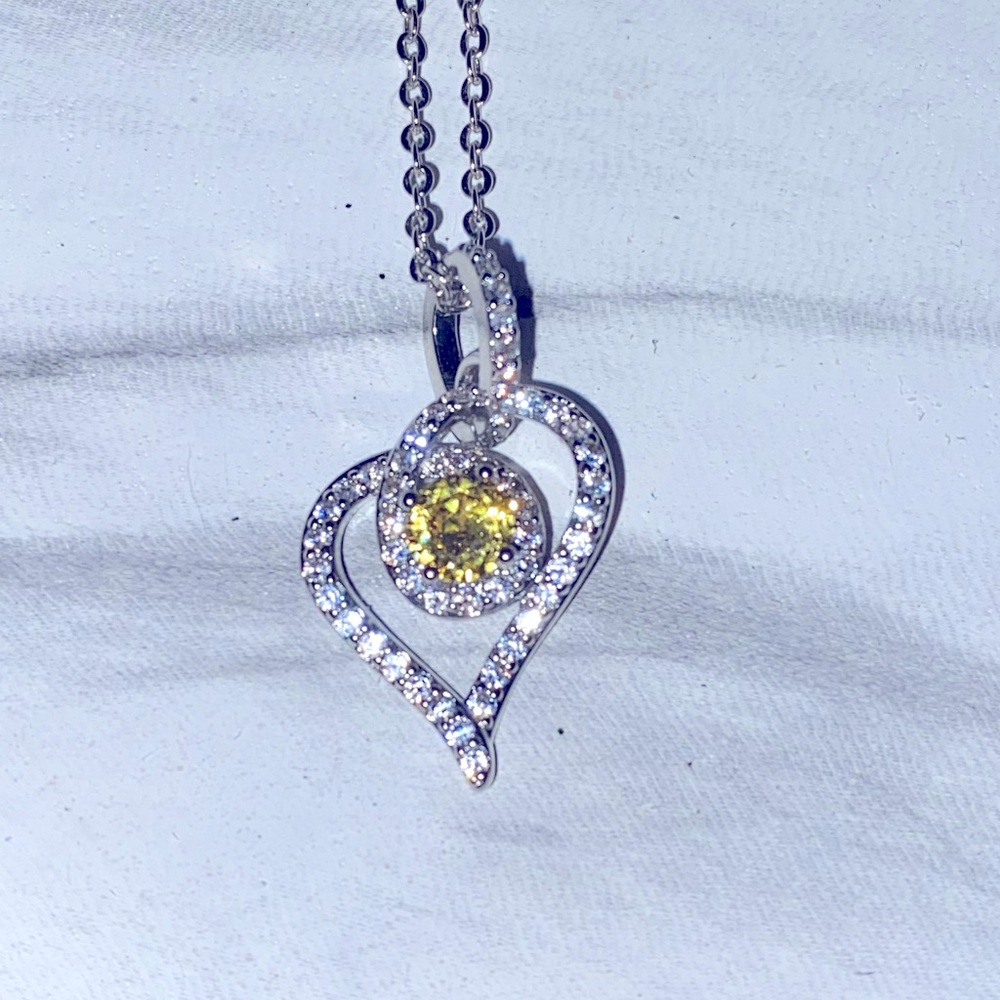 Heart necklace with yellow and clear stones